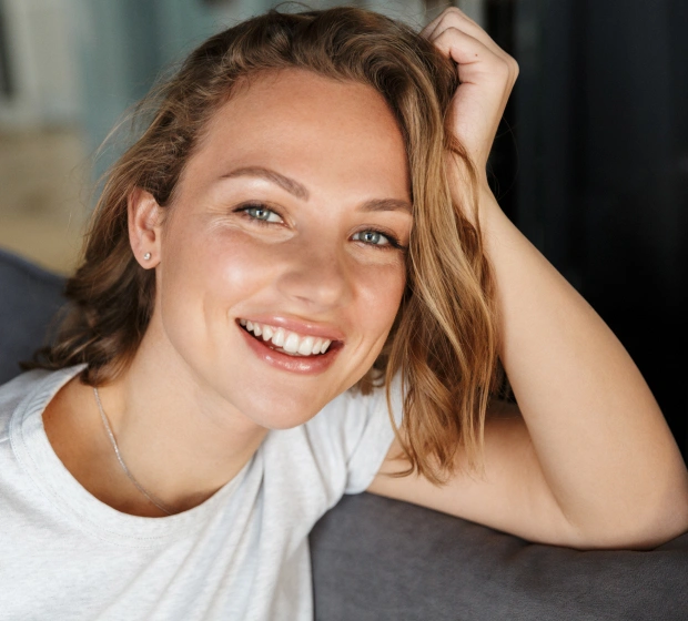 Woman with bright white smile after cosmetic dentistry treatment in Bedford, TX