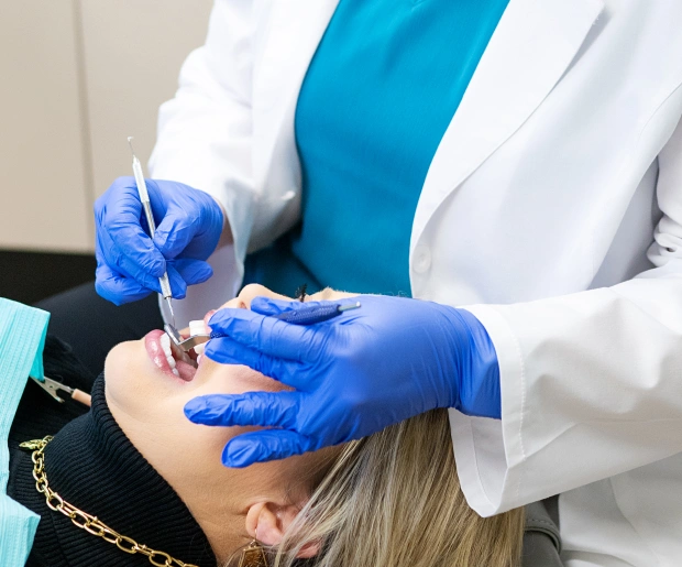 Dentist providing emergency dental treatment to patient in Bedford, TX for urgent dental care and pain relief