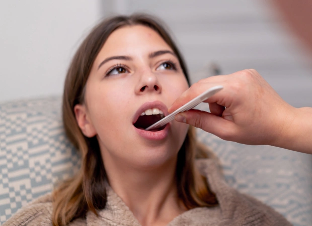 Dentist performing oral cancer screening exam in Bedford, TX to detect early signs of oral disease
