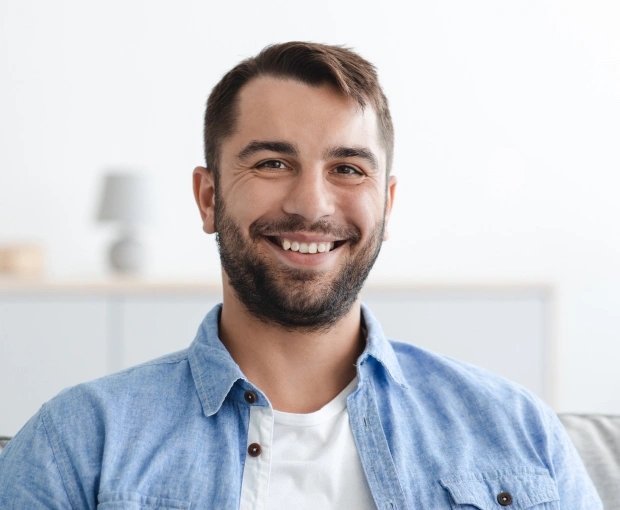 Man with healthy smile after restorative dentistry treatment in Bedford, TX