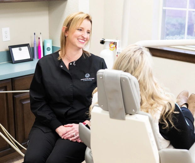 Dentist consulting with patient about smile makeover treatment in Bedford, TX cosmetic dental office